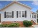 Home's exterior with vinyl siding, black shutters and brick foundation at 13 Herndon Ct, Clayton, NC 27520