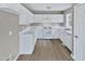 Clean kitchen featuring white cabinets, modern appliances, and neutral countertops at 13 Herndon Ct, Clayton, NC 27520