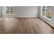 Bright living room featuring neutral walls, wood-look flooring, and large windows at 13 Herndon Ct, Clayton, NC 27520