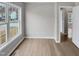 Living room featuring vinyl floors, neutral walls, and a large window at 13 Herndon Ct, Clayton, NC 27520