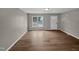Empty living room featuring hardwood flooring and a front door view from the window at 13 Herndon Ct, Clayton, NC 27520