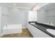 Bathroom featuring a soaking tub and vanity with a large mirror and built in cabinets at 1331 Langdon Pl, Pittsboro, NC 27312