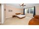 Bedroom featuring a minimalist platform bed, a ceiling fan, and natural light from a window at 1331 Langdon Pl, Pittsboro, NC 27312