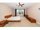 Spacious bedroom with neutral carpet, a ceiling fan, and natural light from a large window at 1331 Langdon Pl, Pittsboro, NC 27312