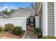 Charming home featuring a decorative black metal gate leading to a brick-paved entrance and well-maintained landscaping at 1331 Langdon Pl, Pittsboro, NC 27312