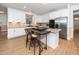 Bright kitchen with white cabinetry, stainless appliances, and an island with seating at 1331 Langdon Pl, Pittsboro, NC 27312