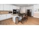 Open kitchen featuring stainless steel appliances, an island with seating, and hardwood flooring at 1331 Langdon Pl, Pittsboro, NC 27312
