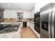 Modern kitchen featuring stainless steel appliances, tile backsplash, and light wood floors at 1331 Langdon Pl, Pittsboro, NC 27312
