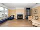 Cozy living room with a fireplace, hardwood floors, and large windows for natural light at 1331 Langdon Pl, Pittsboro, NC 27312