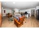 Open-concept living room and kitchen area with wood floors and natural light, connecting living spaces at 1331 Langdon Pl, Pittsboro, NC 27312