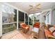 Relaxing screened porch with wicker furniture, brick flooring, and views of the backyard, ideal for outdoor enjoyment at 1331 Langdon Pl, Pittsboro, NC 27312