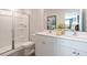 Clean and modern bathroom with a white double vanity and a glass-enclosed shower at 140 Holton St, Smithfield, NC 27577