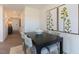 Modern dining area with a sleek dark table, comfortable seating, and elegant wall decor at 140 Holton St, Smithfield, NC 27577