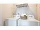 Practical laundry room includes a washing machine and dryer with wire shelving at 140 Holton St, Smithfield, NC 27577