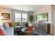 Bright living room with large window, stylish gray sectional sofa, and contemporary media console at 140 Holton St, Smithfield, NC 27577