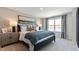 Charming main bedroom features a window, bedside table, and a cozy queen bed with stylish accents at 140 Holton St, Smithfield, NC 27577
