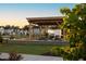 Outdoor community space with pergola, tables, and manicured lawn; perfect for relaxing and socializing at 160 Kobus Ct, Garner, NC 27529