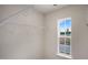 Walk-in closet with shelving for ample storage and a view from a window at 164 Starlight St, Sanford, NC 27330