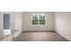 Bright dining room with gray flooring, large window, and neutral walls offers an open and airy space at 164 Starlight St, Sanford, NC 27330