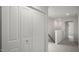 Hallway with neutral carpet, white doors, and staircase access at 164 Starlight St, Sanford, NC 27330