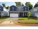 Charming two-story home featuring a two-car garage, brick accents, and a well-manicured front lawn at 165 Klamath Dr, Garner, NC 27529