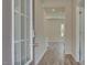 Inviting hallway with wood-look floors leads to an open living space and bedrooms at 165 Klamath Dr, Garner, NC 27529