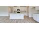 Stylish kitchen with a central island, granite countertops, and sleek stainless steel appliances at 165 Klamath Dr, Garner, NC 27529