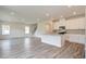 Spacious living room open to the kitchen, featuring wood-look floors and modern recessed lighting at 165 Klamath Dr, Garner, NC 27529