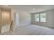 Upstairs living room with plush carpet and bright natural light from large windows at 165 Klamath Dr, Garner, NC 27529