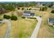 Stunning aerial view of a charming home with a wrap-around porch and a long driveway at 170 Blande Dr, Kenly, NC 27542