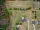 Top-down aerial view of a home on a large lot, featuring mature trees and a private driveway at 170 Blande Dr, Kenly, NC 27542