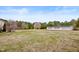Expansive backyard with a storage shed, a garden, and mature trees at 170 Blande Dr, Kenly, NC 27542