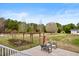 Spacious backyard with a patio, garden beds, and mature trees at 170 Blande Dr, Kenly, NC 27542