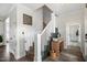 Elegant entryway featuring a staircase with white railings, wood accents, and stylish decor at 170 Blande Dr, Kenly, NC 27542