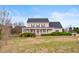 Charming two-story home featuring a welcoming front porch with white railings and a well-maintained lawn at 170 Blande Dr, Kenly, NC 27542