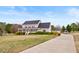 Beautifully landscaped property with a long driveway leading to a two-story home and detached garage at 170 Blande Dr, Kenly, NC 27542