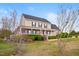 Attractive home with a large front porch, complemented by blooming trees and manicured shrubbery at 170 Blande Dr, Kenly, NC 27542
