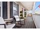 Inviting front porch with comfortable seating, potted plants, and a clear view of the home's entrance at 170 Blande Dr, Kenly, NC 27542