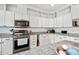 Gourmet kitchen featuring stainless steel appliances, granite countertops, and ample storage at 170 Blande Dr, Kenly, NC 27542
