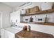 Functional laundry room featuring a washer, dryer, wooden shelves, and ample storage space at 170 Blande Dr, Kenly, NC 27542