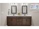 Bathroom with double sink vanity featuring dark wood cabinets and a white countertop at 1726 River Club Way, Franklinton, NC 27525