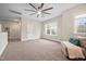 Spacious bedroom featuring a ceiling fan, carpet flooring, a cozy chair, and a window with a view at 1726 River Club Way, Franklinton, NC 27525