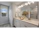 Bathroom featuring double sinks, quartz countertop, a large mirror, and modern fixtures at 180 Kobus Ct, Garner, NC 27529