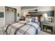 Bedroom with a striped accent wall, decorative lacrosse sticks, and two end tables with lamps at 180 Kobus Ct, Garner, NC 27529
