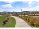 A view of the community playground, picnic area, and townhomes from the walking path at 180 Kobus Ct, Garner, NC 27529