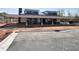 Modern clubhouse exterior showcasing covered patio and ample parking space, partially under construction at 180 Kobus Ct, Garner, NC 27529