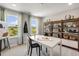Bright art studio with a large table, natural light, and shelving for art supplies at 180 Kobus Ct, Garner, NC 27529