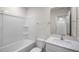 Clean bathroom featuring a shower-tub combo, toilet, and single sink vanity at 180 Starlight St, Sanford, NC 27330