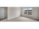 Bedroom featuring carpet flooring and a big window with view at 180 Starlight St, Sanford, NC 27330