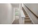 Bright hallway leading to carpeted stairs and an open room with ample natural light and new wood floors at 180 Starlight St, Sanford, NC 27330